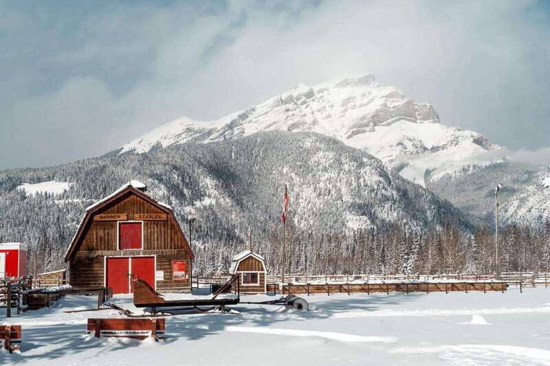 Banff: Family Friendly Horse-Drawn Sleigh Ride - Entering the big red stables on Sundance Road