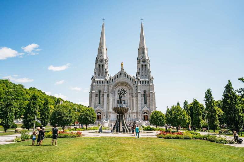 Quebec City: Montmorency Falls & Ile d'Orleans Half-Day Tour - Sainte-Anne-de-Beaupré Basilica and sanctuary time, with a clear focus