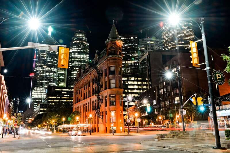 Toronto: Small Group Night Tour with Harbour Boat Cruise - Riding in Comfort: Pickup, Mercedes Metris, and Real Guide Narration